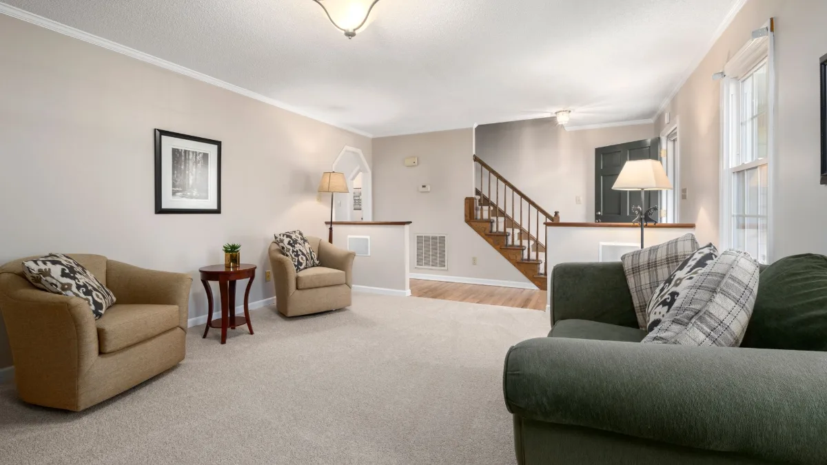 Wall-to-wall beige carpet in a bright East Bay living room
