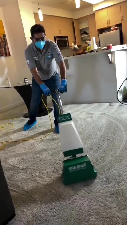 Dr. Carpet technician agitating carpet with a commercial brush machine