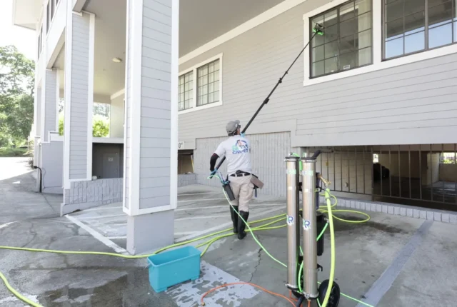 Dr. Carpet technician cleaning upper windows with a water-fed pole and the XERO pure water system in Walnut Creek, CA