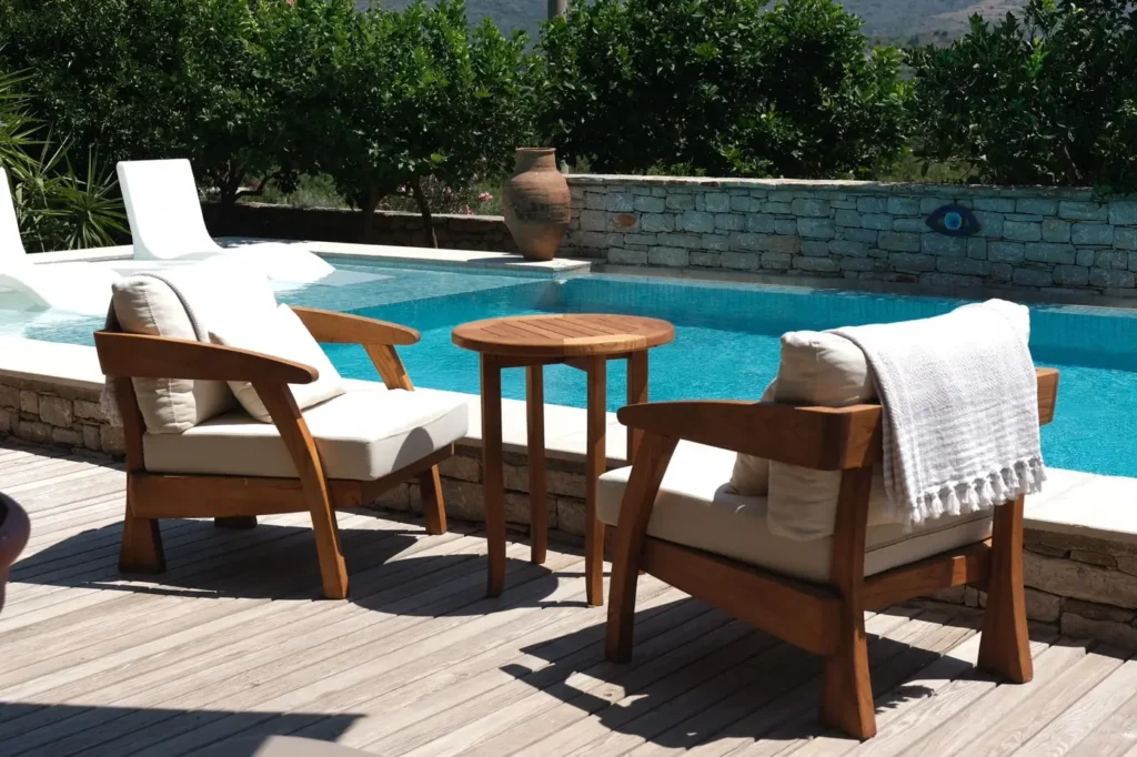 Pool deck lounge chairs with outdoor fabric cushions