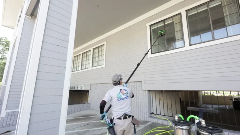 Second-story windows cleaned from the ground with a carbon fiber water-fed pole