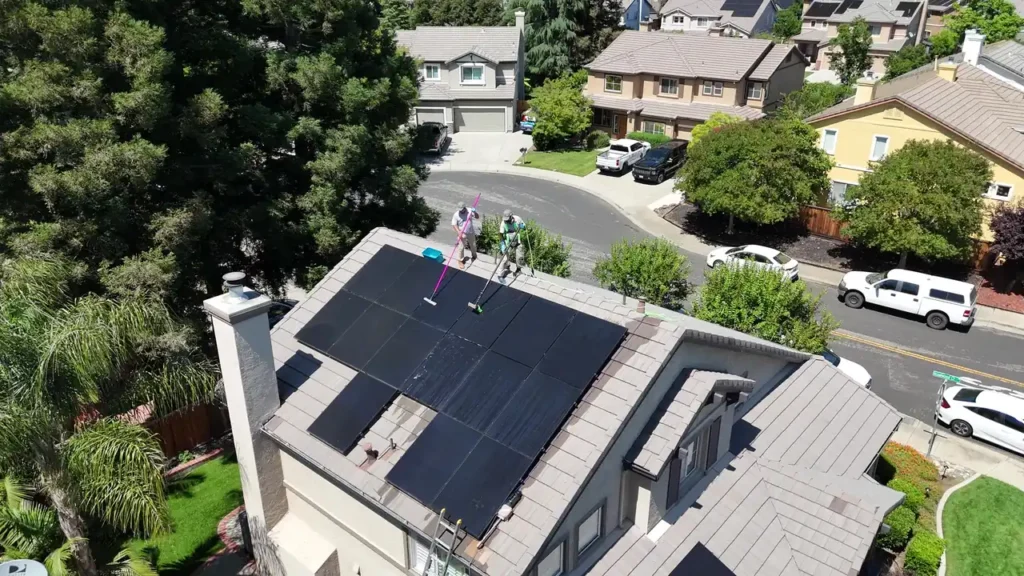 Dr. Carpet technicians cleaning rooftop solar panels with pure water in the East Bay