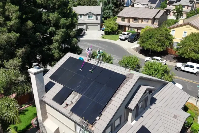 Dr. Carpet technicians cleaning rooftop solar panels with pure water in the East Bay